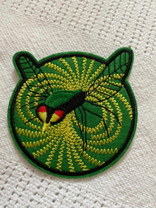 Green Hornet 1967 TV show logo patch with green and yellow embroidered design on fabric background