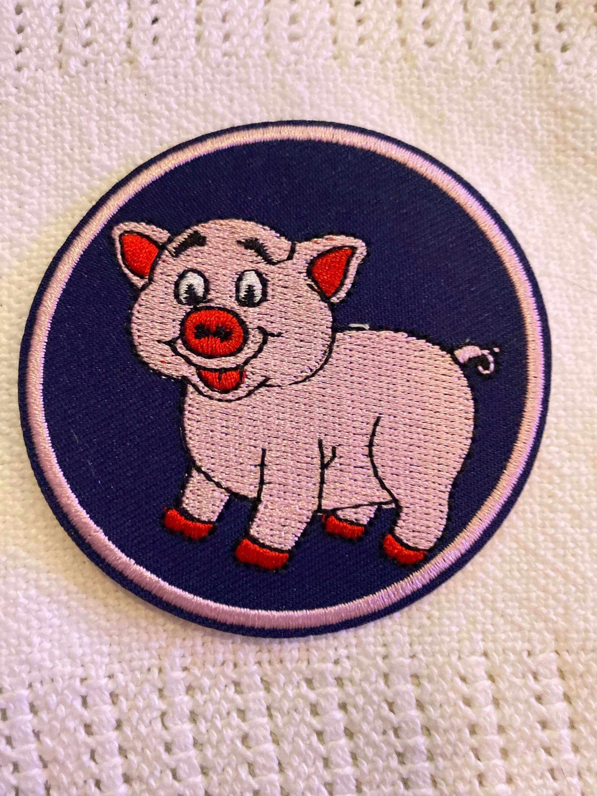 Round patch featuring a cute cartoon pig on a blue background from the Piggy collection