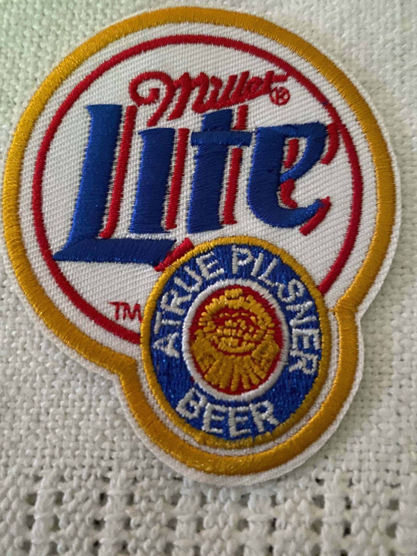 Miller Lite logo patch with red, blue, and yellow embroidery on white fabric background