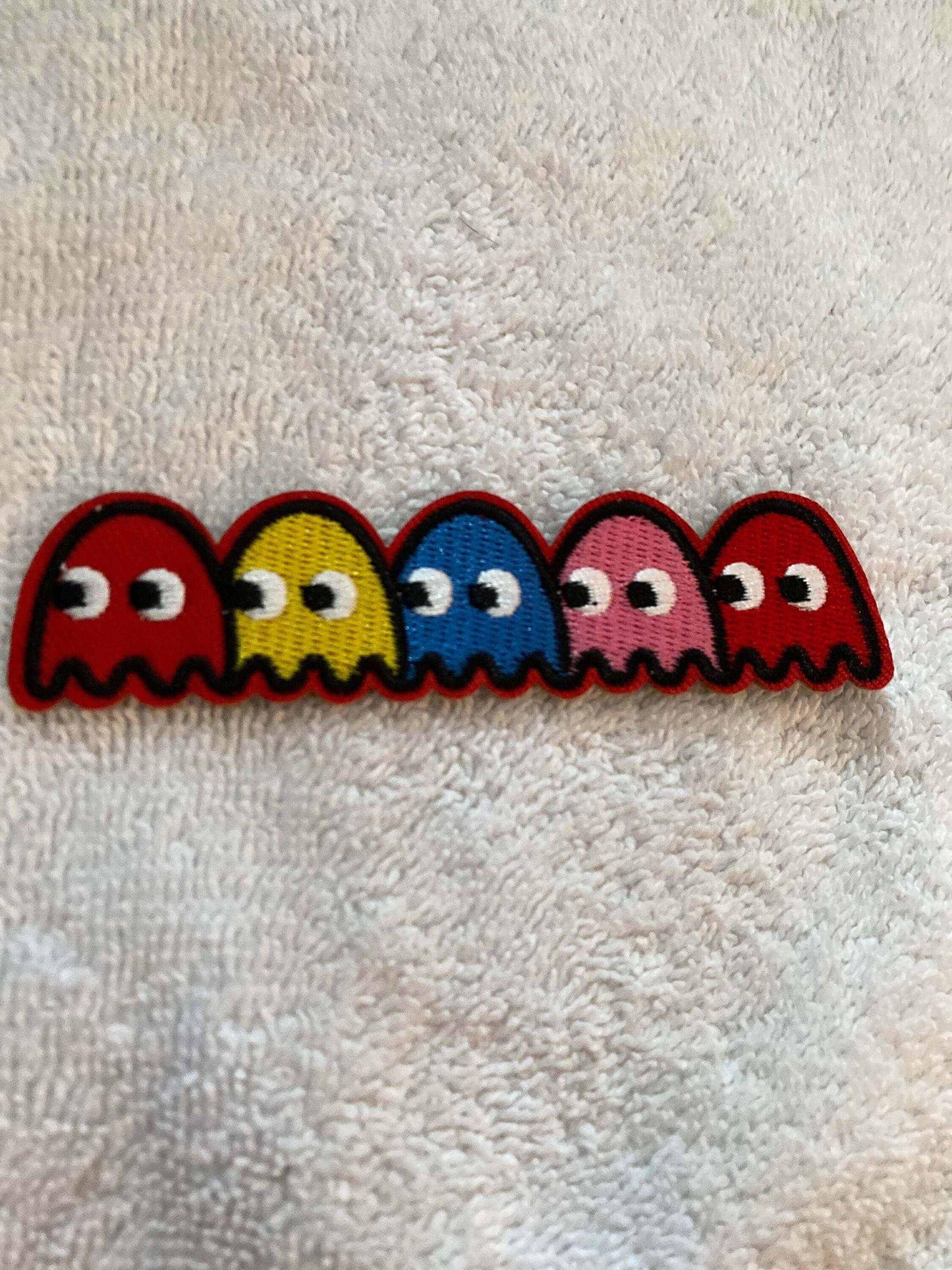 Embroidered patch featuring vibrant Pac Man Ghosts characters in red, yellow, blue, pink, and red colors.