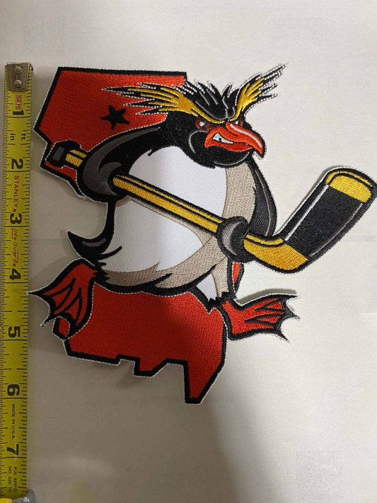 Jersey Rock Hoppers ice hockey team logo patch featuring a penguin with a hockey stick over New Jersey state outline.
