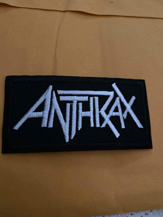 Black rectangular patch with white embroidered Anthrax band logo in bold stylized font