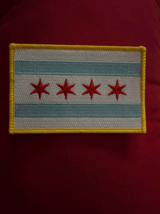 Chicago PD patch with four red stars and blue stripes on a white background with yellow border