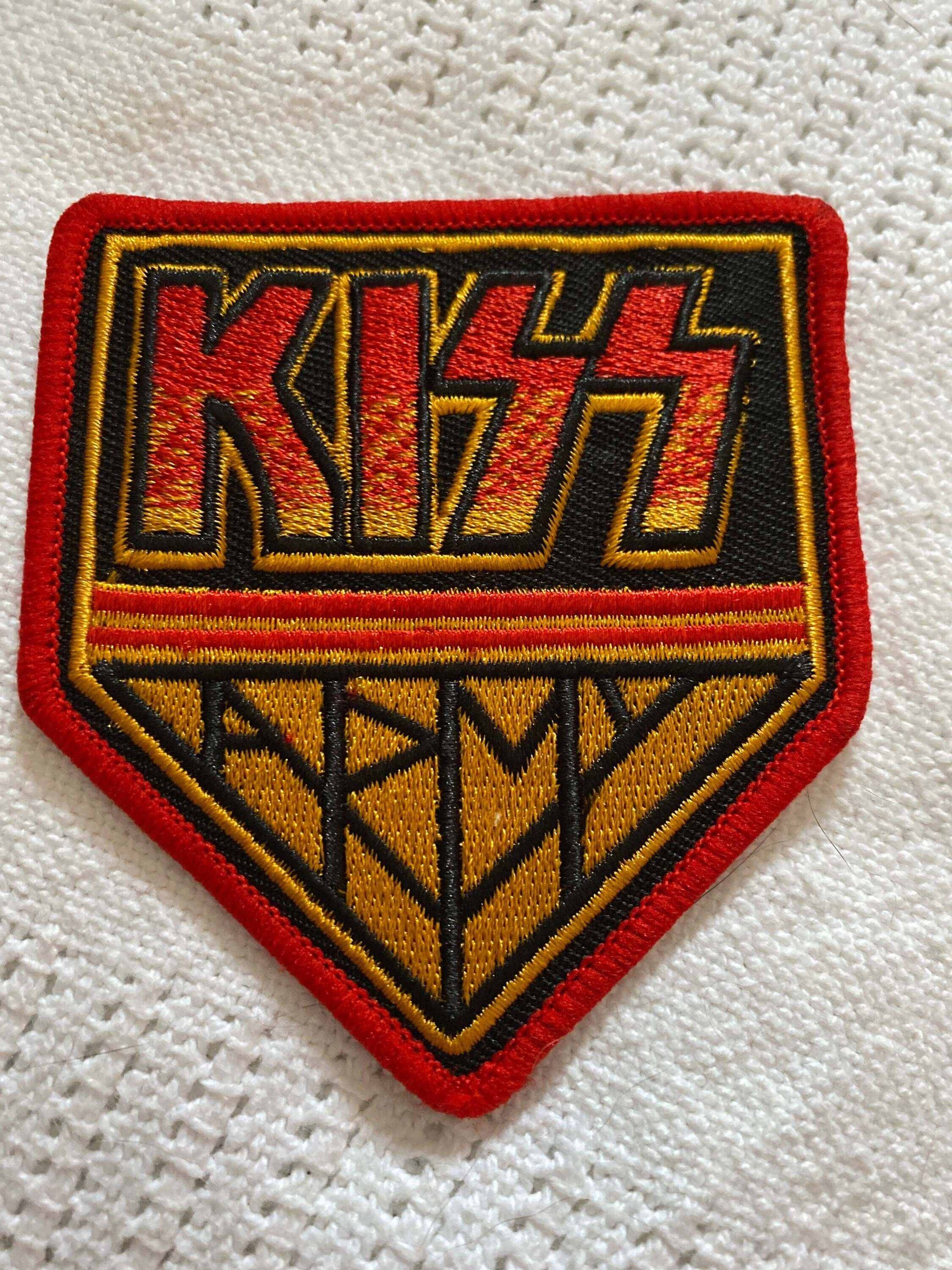 KISS Army logo patch with red and yellow embroidery on black fabric, featuring bold lettering and a red border.