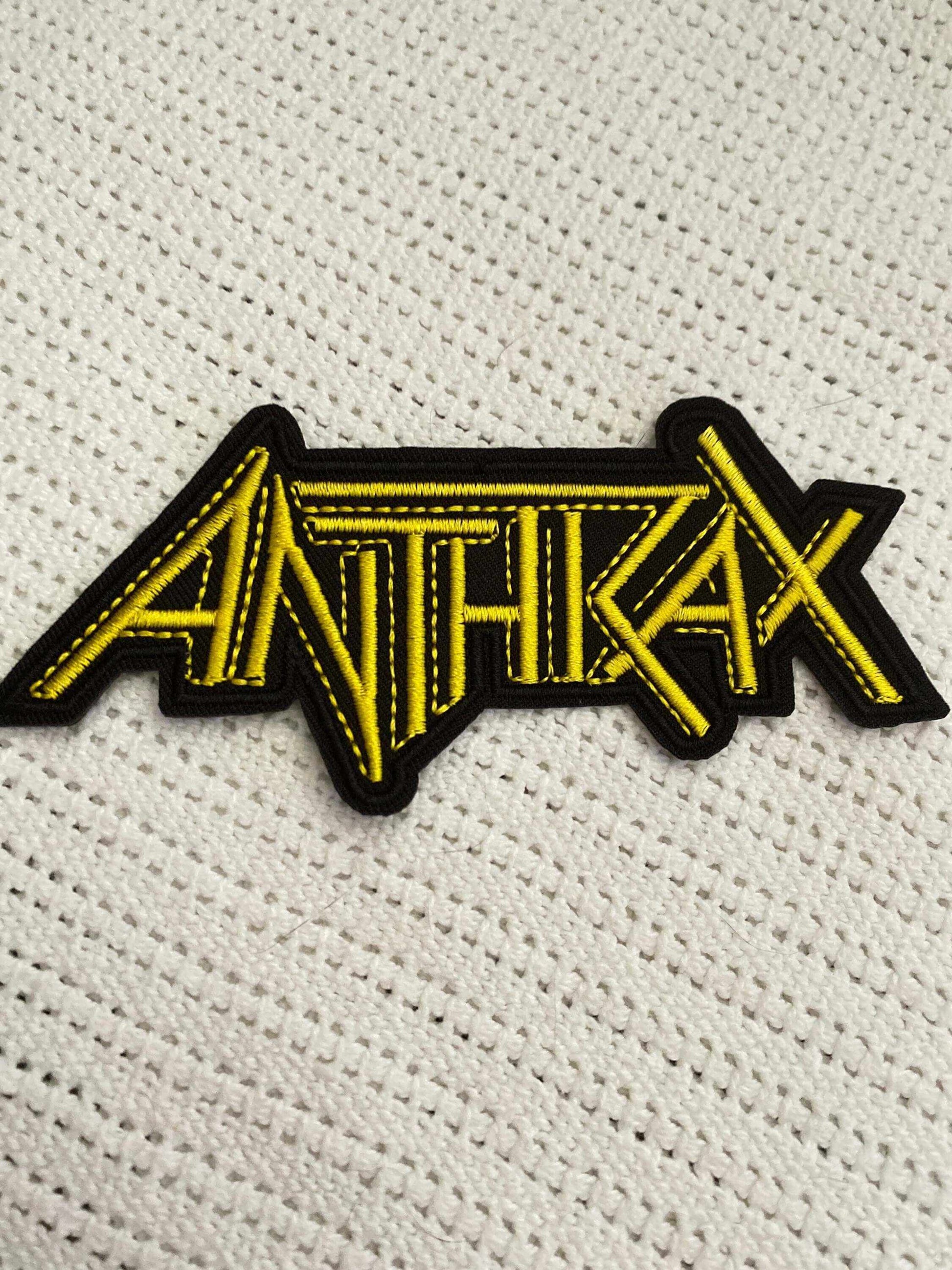 Anthrax logo patch in bold yellow embroidery on black background, perfect for thrash metal fans and bold style.