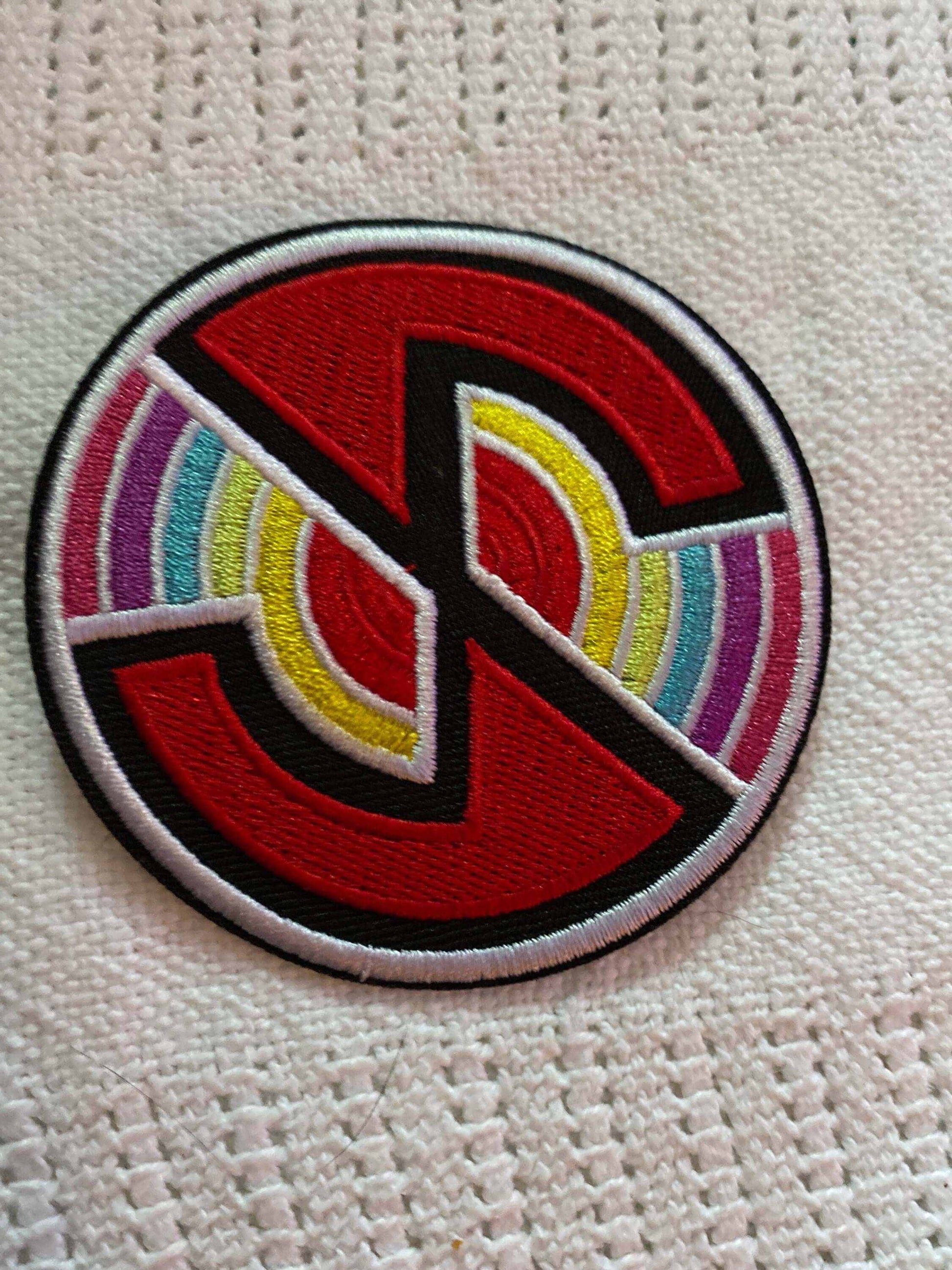 Captain Scarlet SPECTRUM embroidered logo patch with retro-futuristic colorful design on fabric background