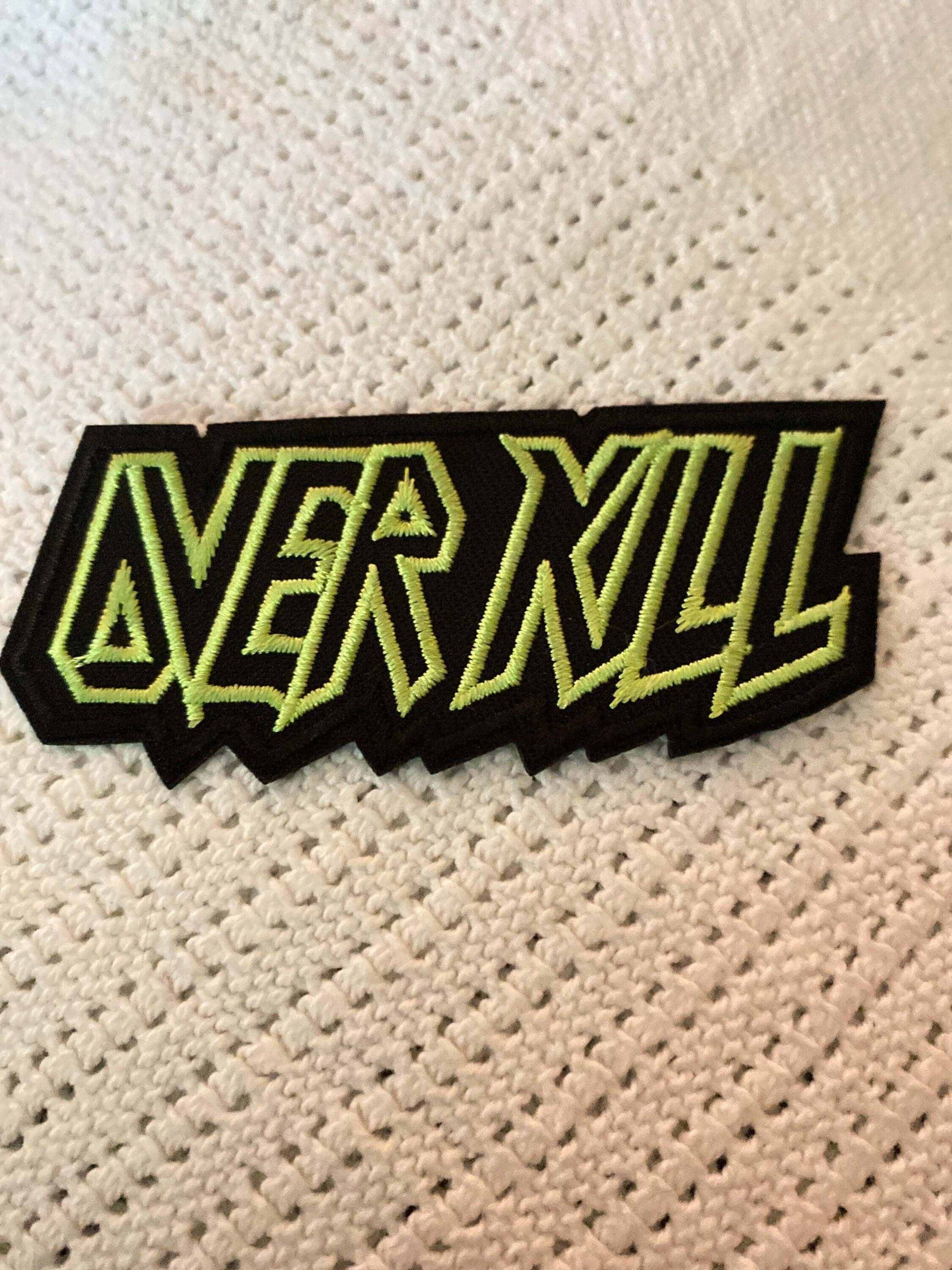 Over Kill embroidered patch with bold yellow-green outlined text on black background